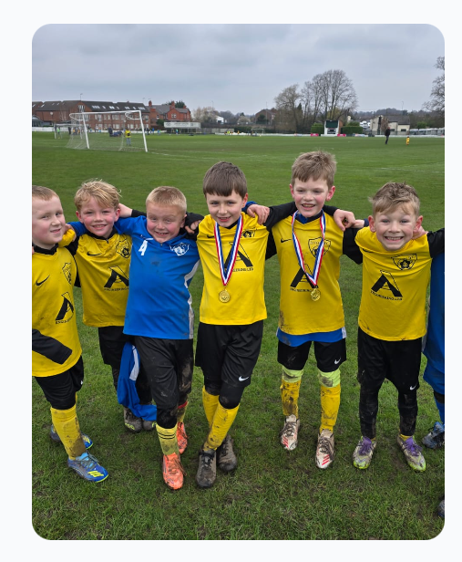 U9s Yellows celebrating with medals